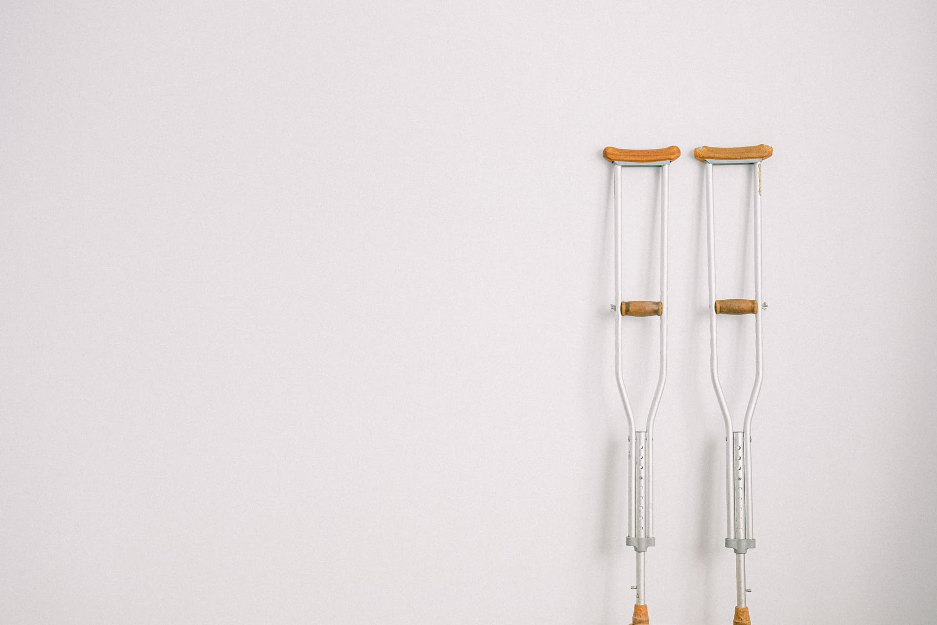 A magnetic rowing machine folded upright against a wall at home