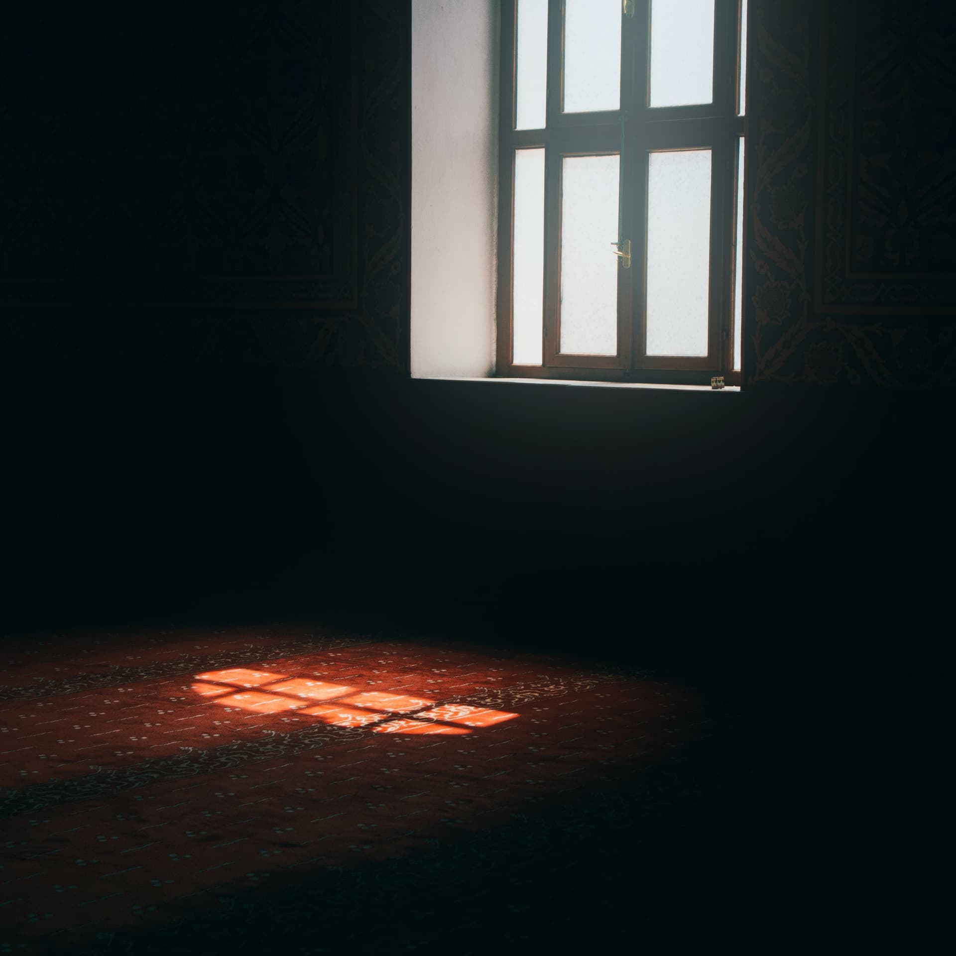 A calm, softly lit room with exercise equipment against a plain wall
