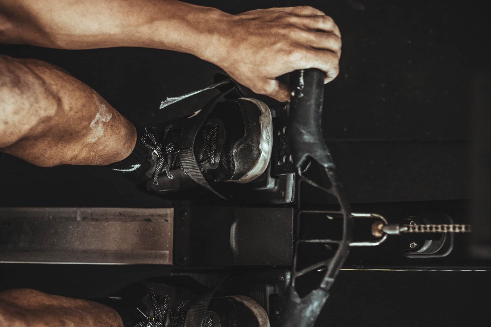 The seat rail and handle of an indoor rower in close detail